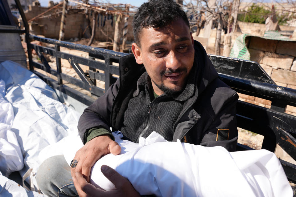 A Syrian man weeps near the bodies of a family and close neighbors who were killed as their family house collapsed during the deadly earthquake that hit Turkey and Syria, during which one newborn baby survived, on February 7, 2023. / Credit: RAMI AL SAYED/AFP via Getty Images