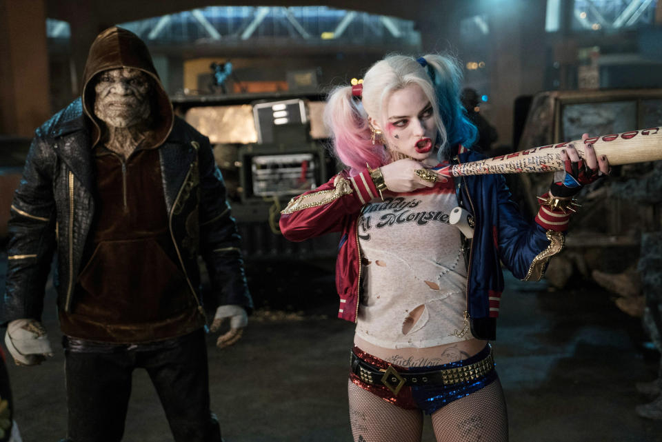 Harley in sequin two-colored underwear with a studded belt, a ripped t-shirt that says "daddy's little monster", and a two-color bomber jacker