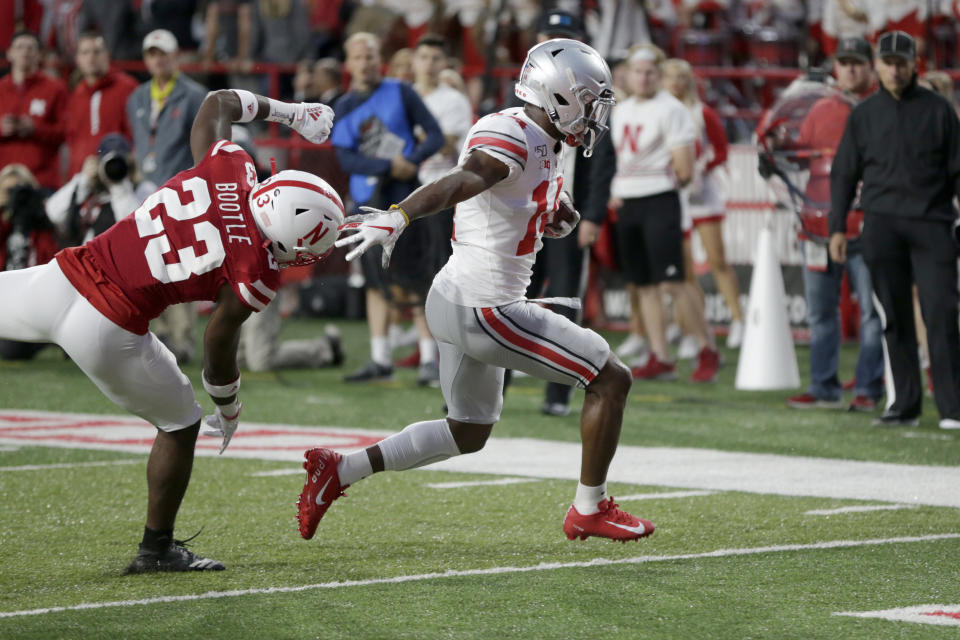 Ohio State wide receiver K.J. Hill (14) runs for a touchdown in front of Nebraska cornerback Dicaprio Bootle (23) during the first half of an NCAA college football game in Lincoln, Neb., Saturday, Sept. 28, 2019. (AP Photo/Nati Harnik)