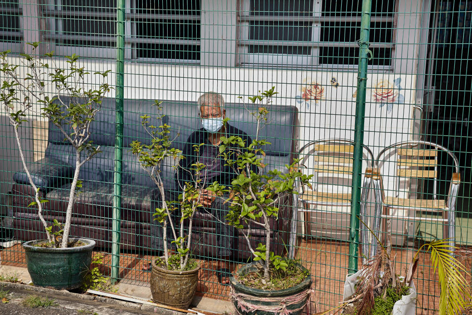 HONG KONG, CHINA - 2022/03/21: An elderly man sits outside the retirement home where he lives in Hong Kong. More than half of those who died from Covid in Hong Kong were residents of homes for the elderly. These care homes are occupied by almost 60,000 people and about 14,700 of them have been infected since the start of the fifth wave. (Photo by Emmanuel Serna/SOPA Images/LightRocket via Getty Images)