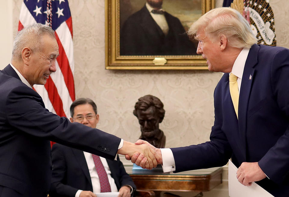 WASHINGTON, DC - OCTOBER 11:  U.S. President Donald Trump shakes hands with Chinese Vice Premier Liu He after announcing a "phase one" trade agreement with China in the Oval Office at the White House October 11, 2019 in Washington, DC.  China and the United States have slapped each other with hundreds of billions of dollars in tariffs since the current trade war began between the world’s two largest national economies in 2018. (Photo by Win McNamee/Getty Images)