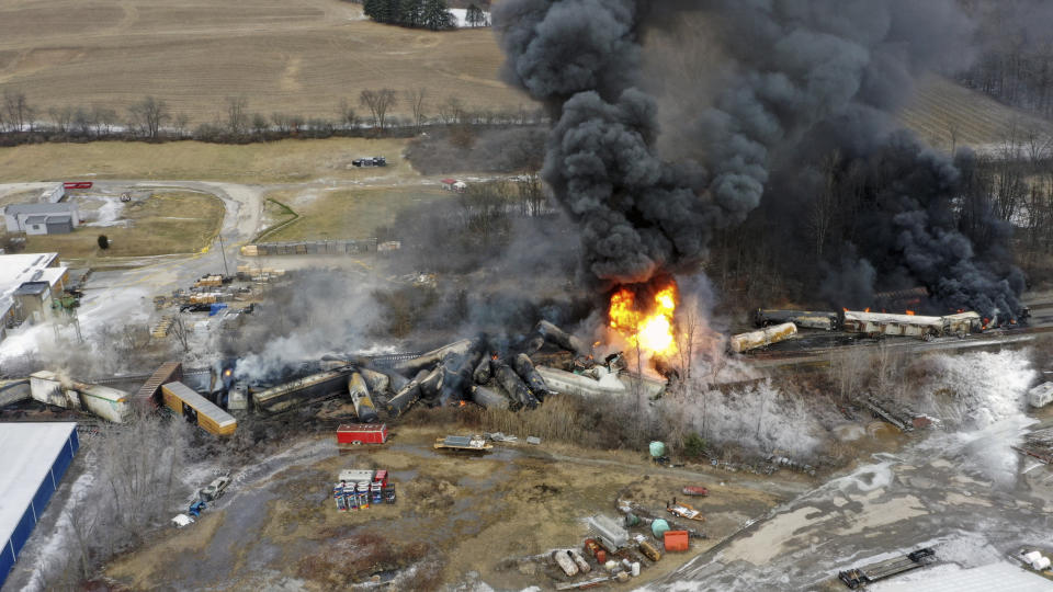 This photo taken with a drone shows portions of a Norfolk and Southern freight train that derailed Friday night in East Palestine, Ohio are still on fire at mid-day Saturday, Feb. 4, 2023. (AP Photo/Gene J. Puskar)