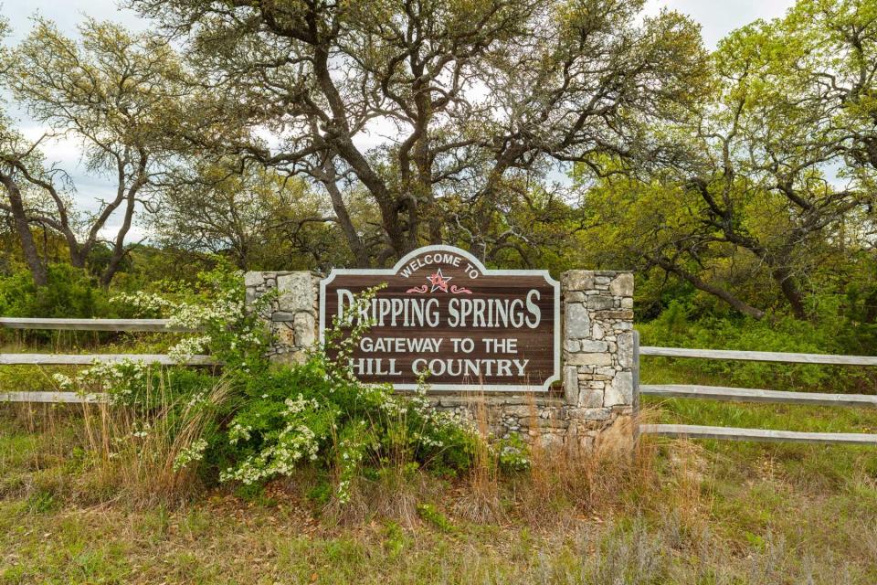 Pretty welcome sign upon entering this small town in the Texas Hill Country in Hays County in scenic central Texas.