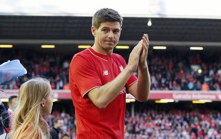 Football - Liverpool v Crystal Palace - Barclays Premier League - Anfield - 16/5/15 Liverpool's Steven Gerrard applauds fans as he walks on the pitch with his family after his final game at Anfield REUTERS/Phil Noble