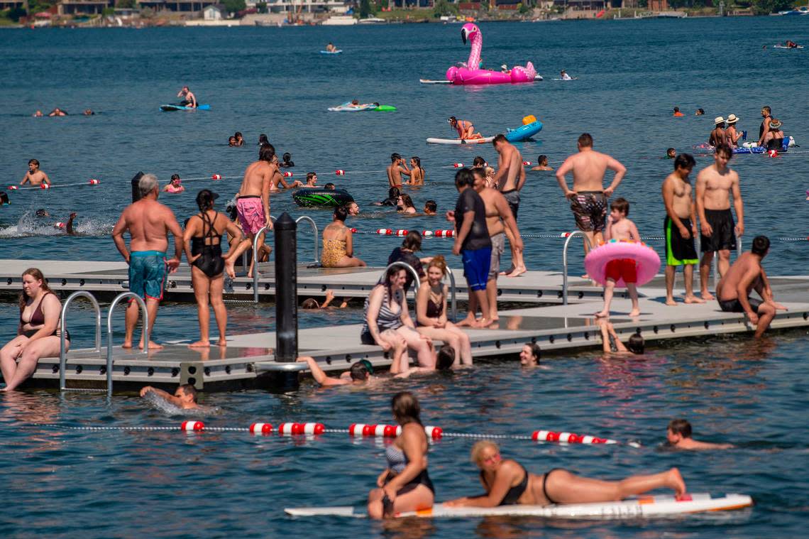 Hundreds pack the floating docks of Lake Whatcom to combat the record heat in Washington.