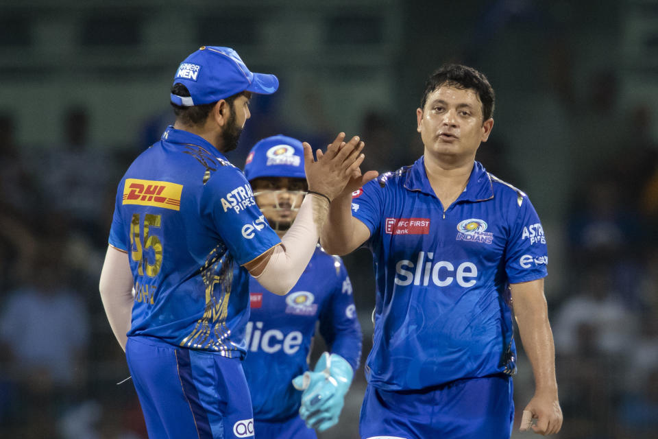 Mumbai Indians' Piyush Chawla, right, celebrates with captain Rohit Sharma the wicket of Lucknow Super Giants' captain Krunal Pandya during the Indian Premier League cricket eliminator match between Mumbai Indians and Lucknow Super Giants in Chennai, India, Wednesday, May 24, 2023. (AP Photo /R. Parthibhan)