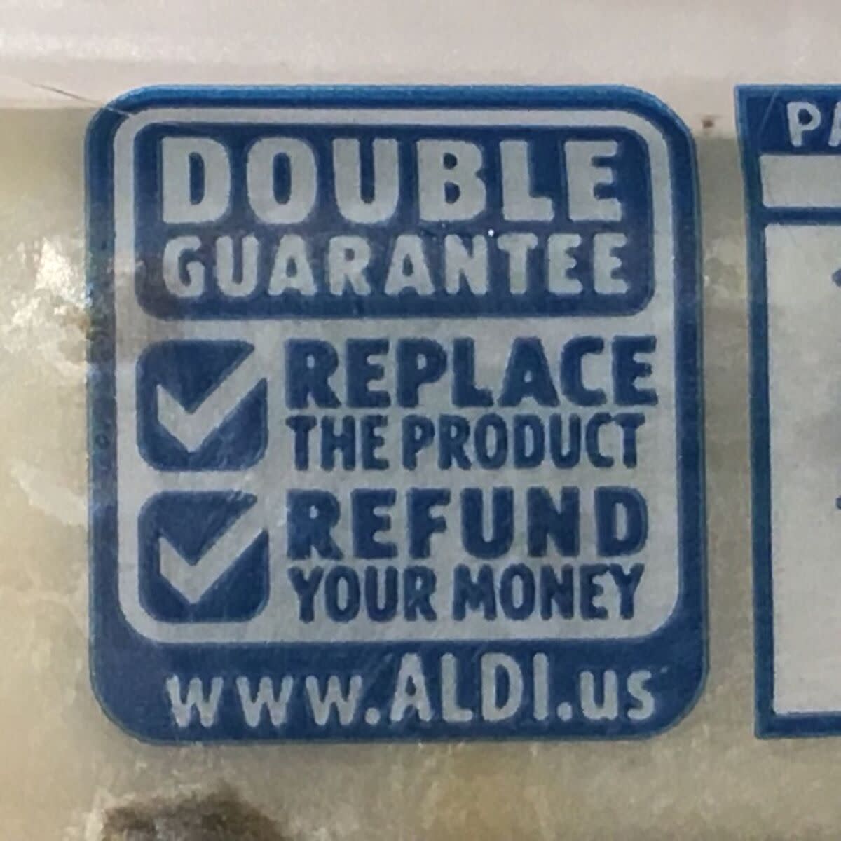 Closeup of Aldi's 'Double Guarantee' policy on a package of Aldi brand white cheese at Aldi, Arcadia, California