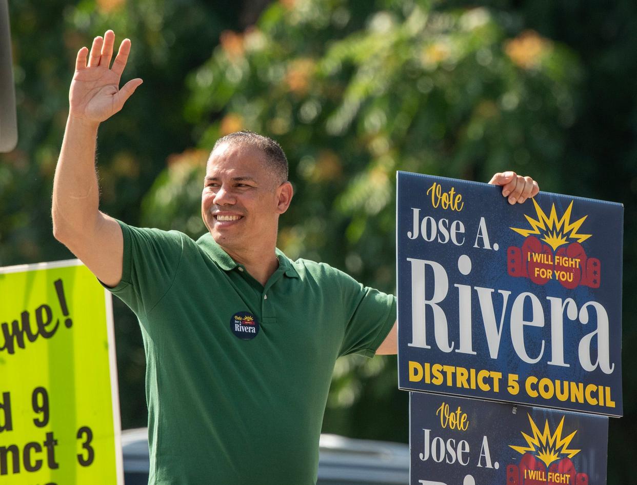 Jose Rivera campaigns outside the polls at Christ The King Catholic Church on Tuesday.