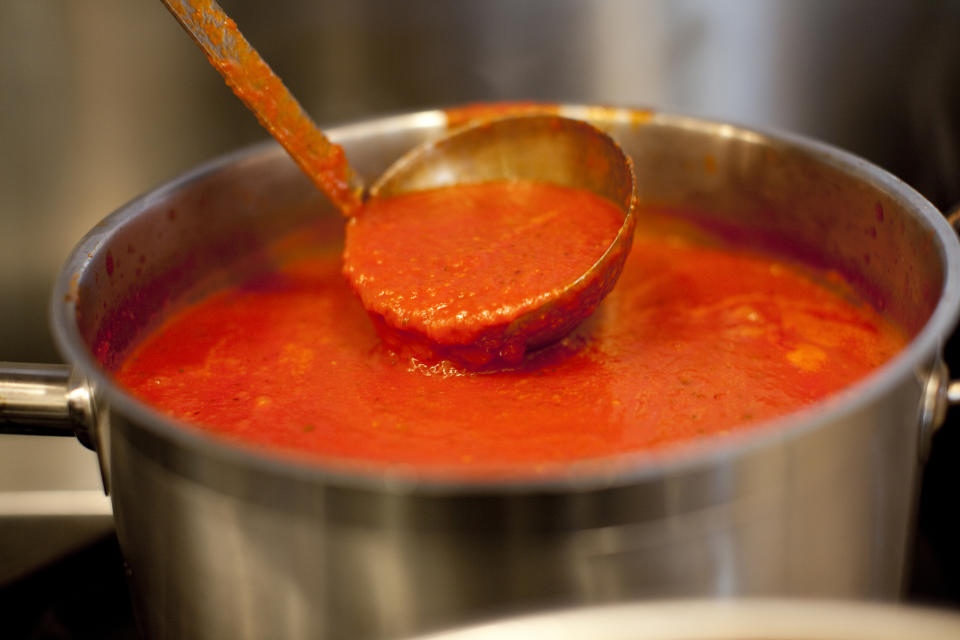 ladle in a pot of marinara sauce