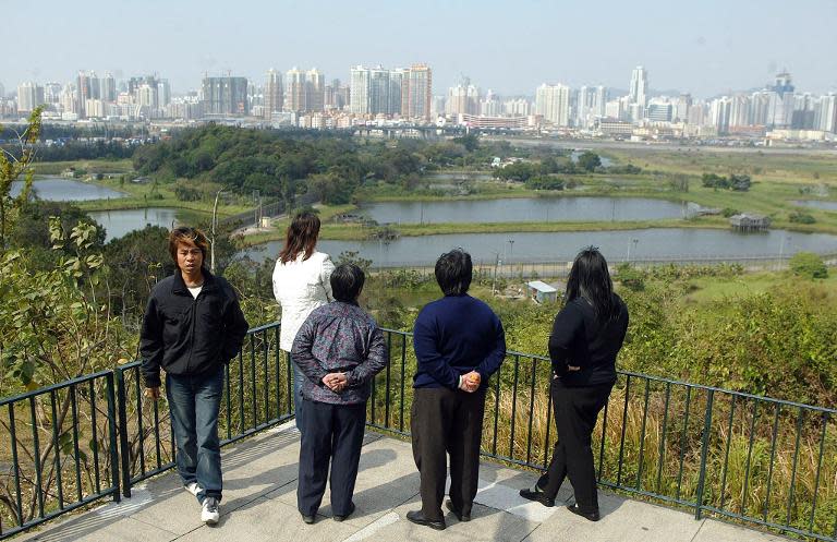 Hong Kong residents look over the border to the Chinese boom city of Shenzhen where in 2014 authorities blocked sales of Kaisa's property units in a move allegedly linked to a graft investigation