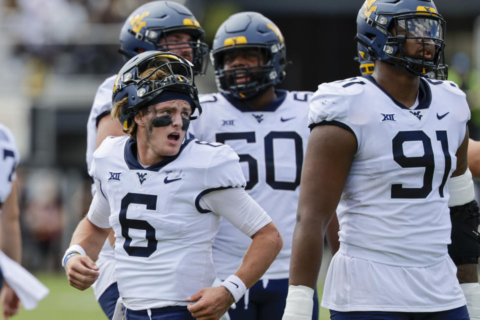 West Virginia quarterback Garrett Greene (6) watches as his touchdown is reviewed during the first half of an NCAA college football game Central Florida, Saturday, Oct. 28, 2023, in Orlando, Fla. (AP Photo/Kevin Kolczynski)