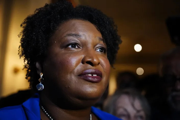 Georgia gubernatorial Democratic candidate Stacey Abrams talks to the media after qualifying for the 2022 election on Tuesday, March 8, 2022, in Atlanta. Abrams has no announced opposition for governor for the Democratic nomination. (AP Photo/Brynn Anderson)