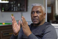 Former England international soccer player Ricky Hill poses for a photograph in Luton, England, Wednesday, March 20, 2024. Racism has long permeated the world’s most popular sport, with soccer players subjected to racist chants and taunts online. While governing bodies like FIFA and UEFA have taken steps to combat the abuse of players, the lack of diversity in the upper ranks at major clubs remains an unsolved problem. Hill has just left the U.K. to take a management position with a suburban Chicago soccer club. (AP Photo/Kin Cheung)