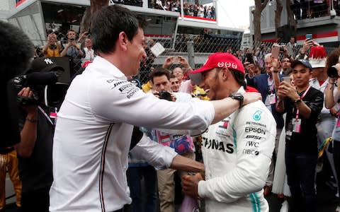 Lewis Hamilton is congratulated on his victory by Mercedes team principal Toto Wolff - Credit: Reuters