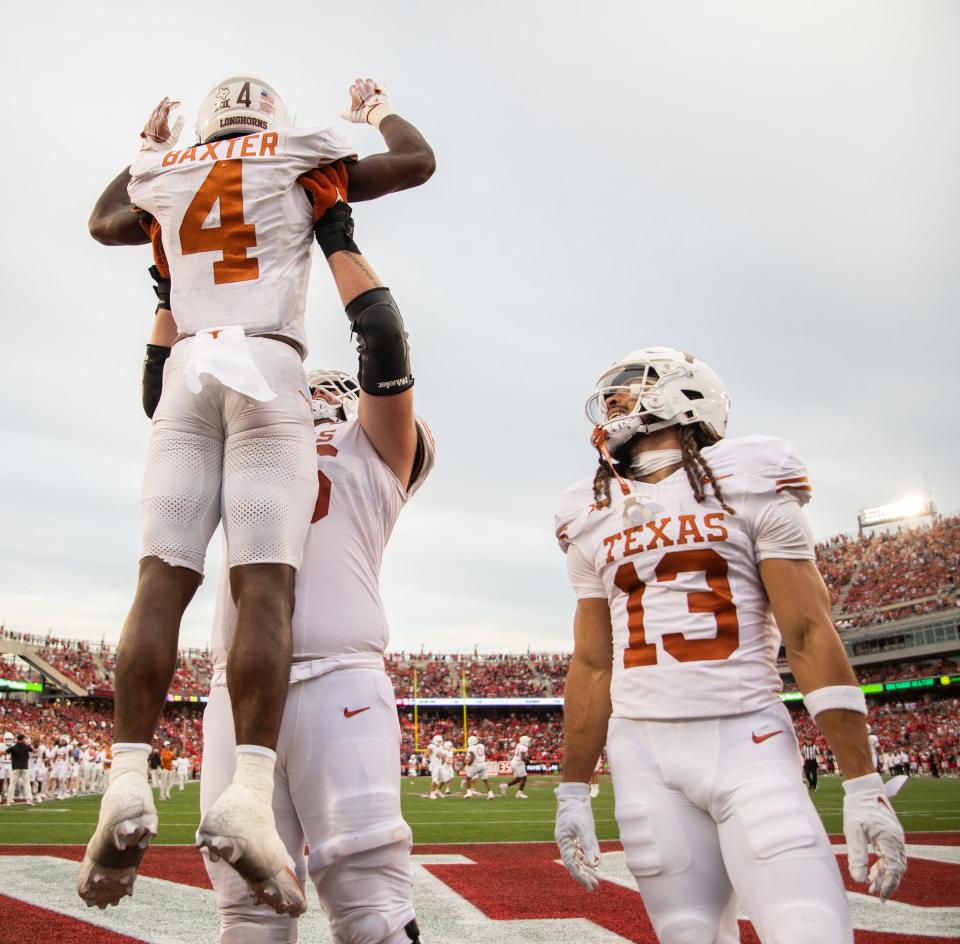 Texas running back CJ Baxter (4) celebrates after scoring the game-winning touchdown in the fourth quarter of the Longhorn's game against the Houston Cougars at TDECU Stadium in Houston, Saturday, Oct. 21, 2023. Texas won the game 31-24.