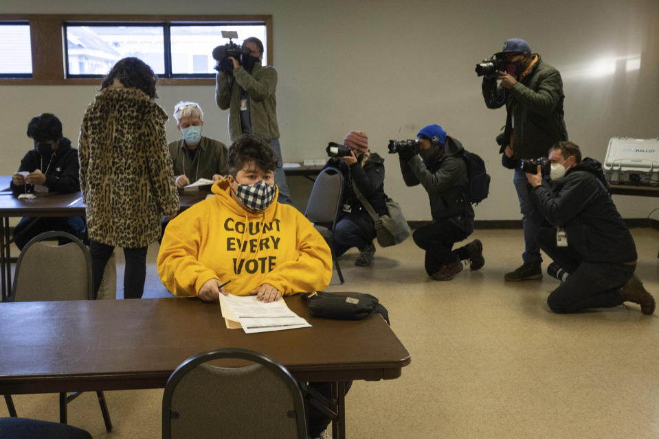 Photojournalists document mayoral candidate Sheila Nezhad as she walks into the Gichitwaa Kateri Catholic Church on Election Day to cast her vote on Tuesday, Nov. 2, 2021 in Minneapolis. Voters in Minneapolis are deciding whether to replace the city's police department with a new Department of Public Safety. The election comes more than a year after George Floyd's death launched a movement to defund or abolish police across the country.(AP Photo/Christian Monterrosa)