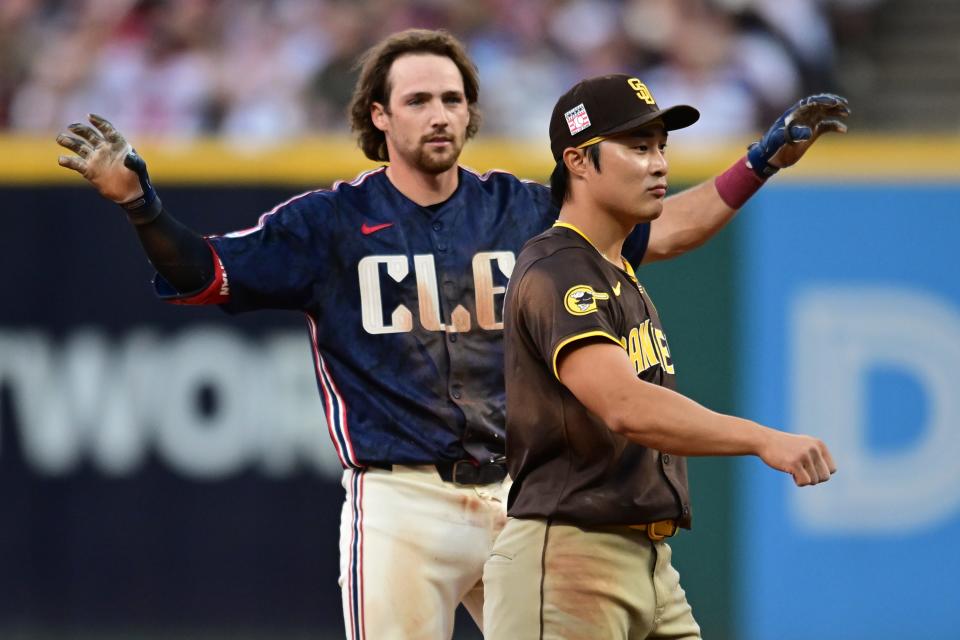 Jul 19, 2024; Cleveland, Ohio, USA; Cleveland Guardians shortstop Daniel Schneemann (10) celebrates after hitting an RBI double as San Diego Padres shortstop Ha-Seong Kim (7) looks on during the fifth inning at Progressive Field. Mandatory Credit: Ken Blaze-USA TODAY Sports