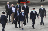 Former U.S. senator Chris Dodd, center left is followed by former U.S. Deputies Secretary of State James Steinberg and Richard Armitage as they are shown the way by Taiwan Foreign Minister Joseph Wu, center right upon arrival in Taipei, Taiwan on Wednesday, April 14, 2021. The former U.S. senator and two ex-State Department officials arrived in Taiwan on Wednesday at a time of tense relations with China, Taiwan's Foreign Ministry said. (Pool Photo via AP)