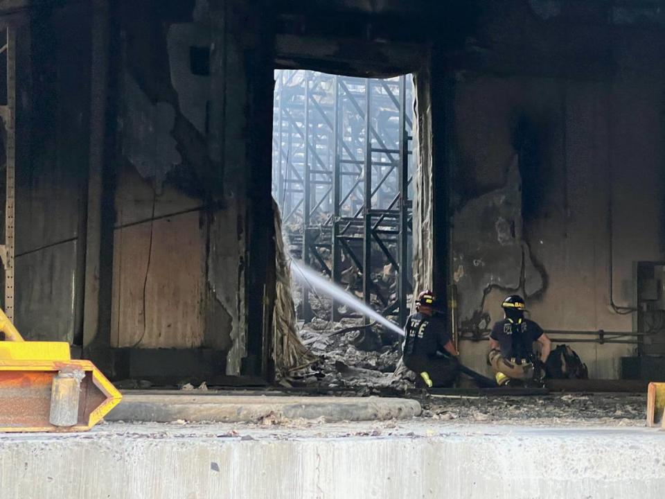 Firefighters spray water on what remains of the Kennewick Lineage cold storage warehouse in Finley.