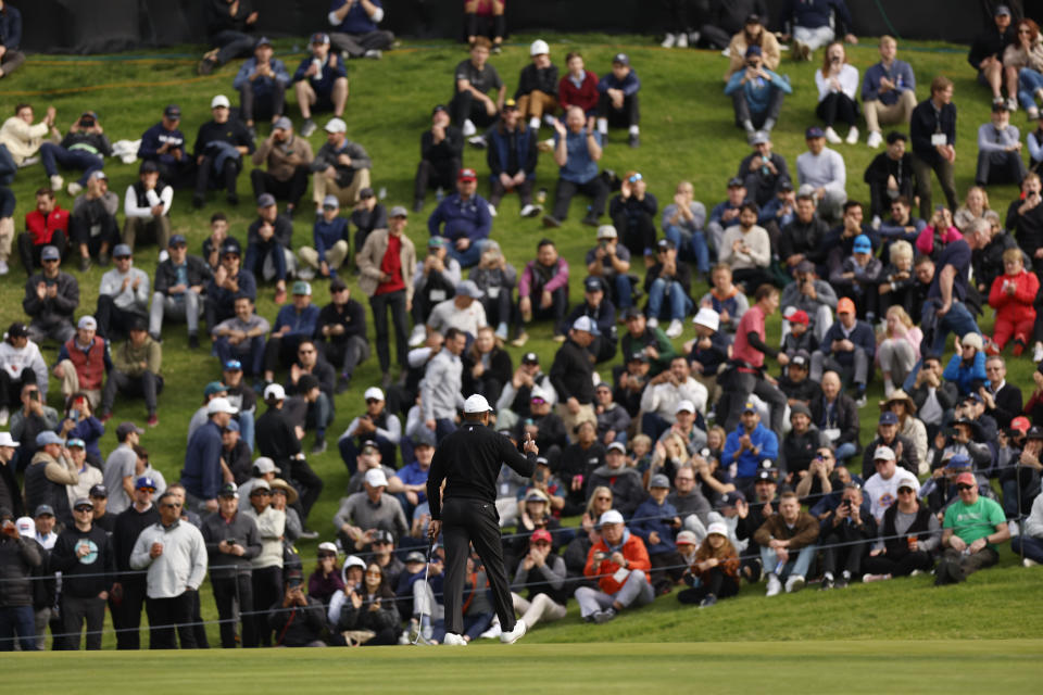 Tiger Woods waves to the gallery on the 18th hole during the second round of the Genesis Invitational golf tournament at Riviera Country Club, Friday, Feb. 17, 2023, in the Pacific Palisades area of Los Angeles. (AP Photo/Ryan Kang)