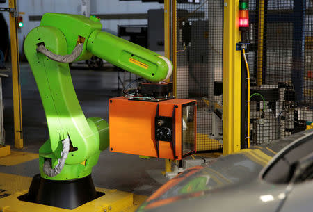 A Collaborative Robot is seen at the headlight alignment station for 2018 Chevrolet Bolt EV and Sonic vehicles on the assembly line at General Motors Orion Assembly in Lake Orion, Michigan, U.S., March 19, 2018. REUTERS/Rebecca Cook/Files