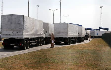 Trucks of a Russian convoy carrying humanitarian aid for Ukraine drive onto the territory of a Russia-Ukraine border crossing point "Donetsk" in Russia's Rostov Region, August 22, 2014. REUTERS/Alexander Demianchuk