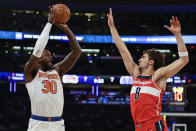 New York Knicks forward Julius Randle (30) shoots over Washington Wizards forward Deni Avdija (8) during the first half of a preseason NBA basketball game Wednesday, Oct. 18, 2023, in New York. (AP Photo/Adam Hunger)