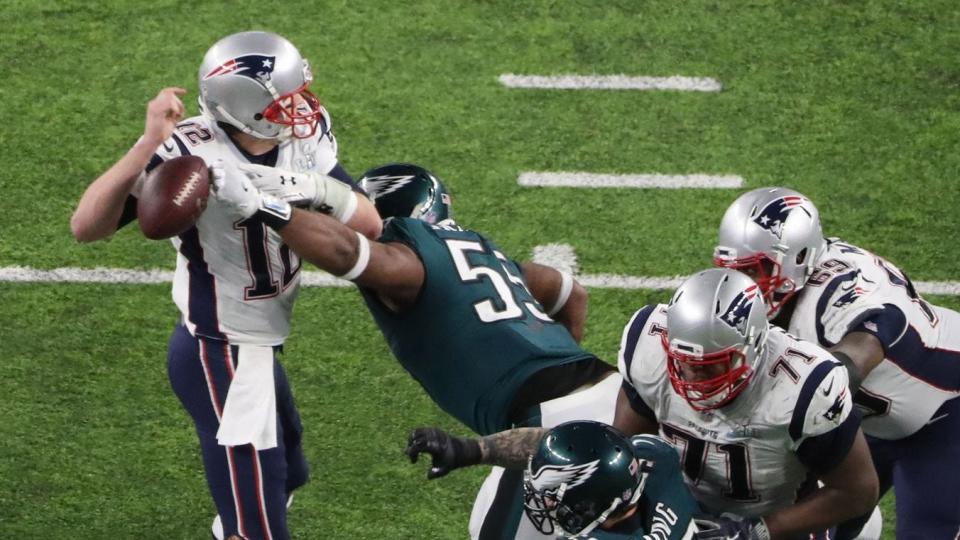 Feb 4, 2018; Minneapolis, MN, USA; New England Patriots quarterback Tom Brady (12) fumbles the ball as he is hit by Philadelphia Eagles defensive end Brandon Graham (55) during the fourth quarter in Super Bowl LII at U.S. Bank Stadium. Mandatory Credit: Kevin Jairaj-USA TODAY Sports