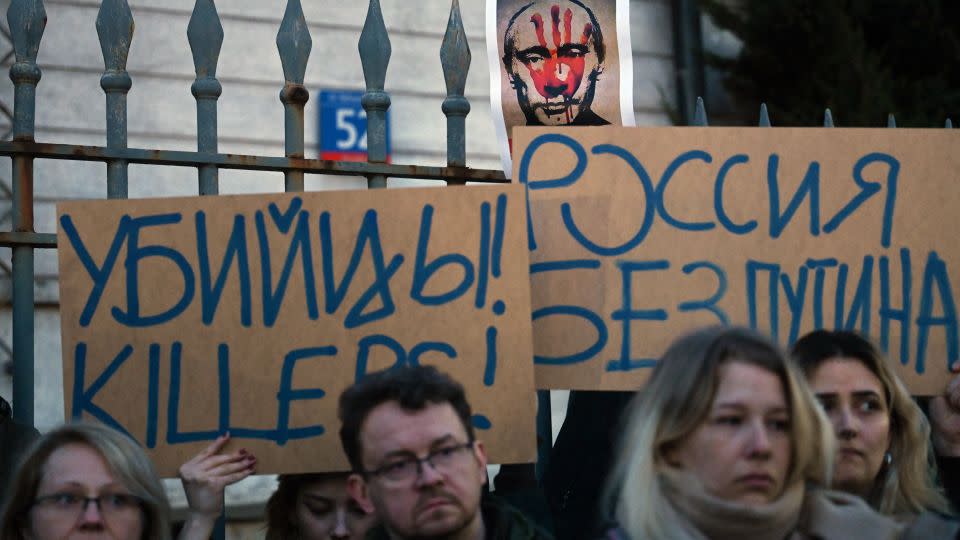 Demonstrators hold placards reading 'Killers' and 'Russia without Putin' during a rally in front of the Russian embassy in Warsaw on February 16 following the announcement that Alexey Navalny had died. (Photo by Sergei GAPON / AFP) (Photo by SERGEI GAPON/AFP via Getty Images) - Sergei Gapon/AFP/Getty Images