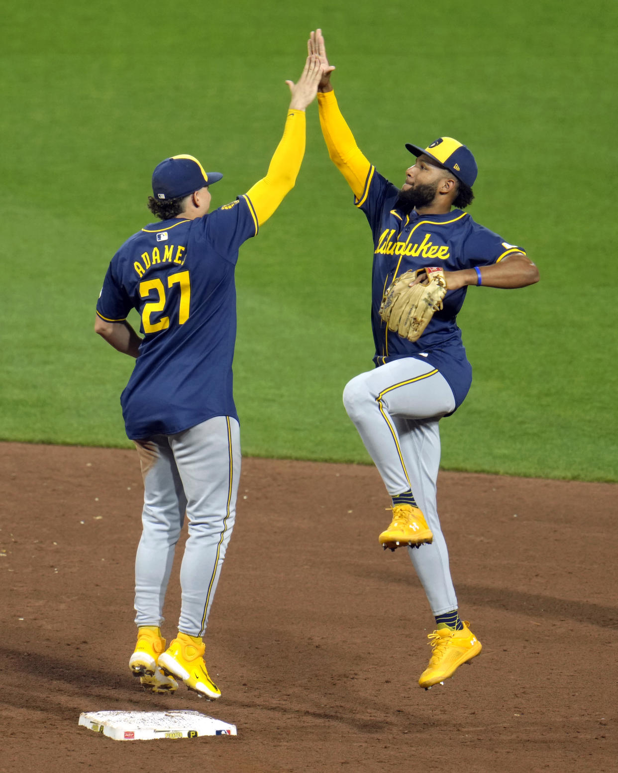 Milwaukee Brewers' Jackson Chourio, right, celebrates with Willy Adames (27) after the final out of a baseball game against the Pittsburgh Pirates in Pittsburgh, Tuesday, Sept. 24, 2024. The Brewers won 7-2. (AP Photo/Gene J. Puskar)