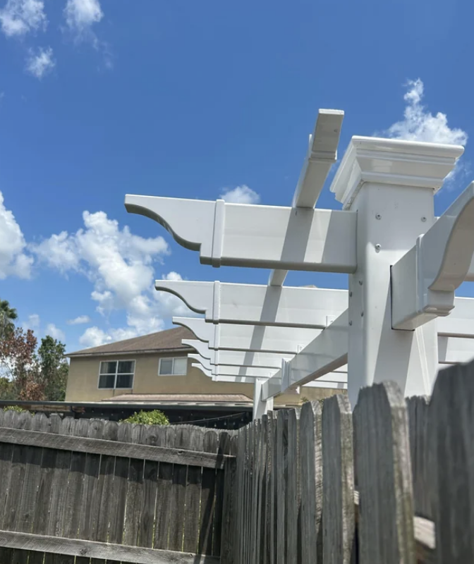 A pergola reaching over someone's fence