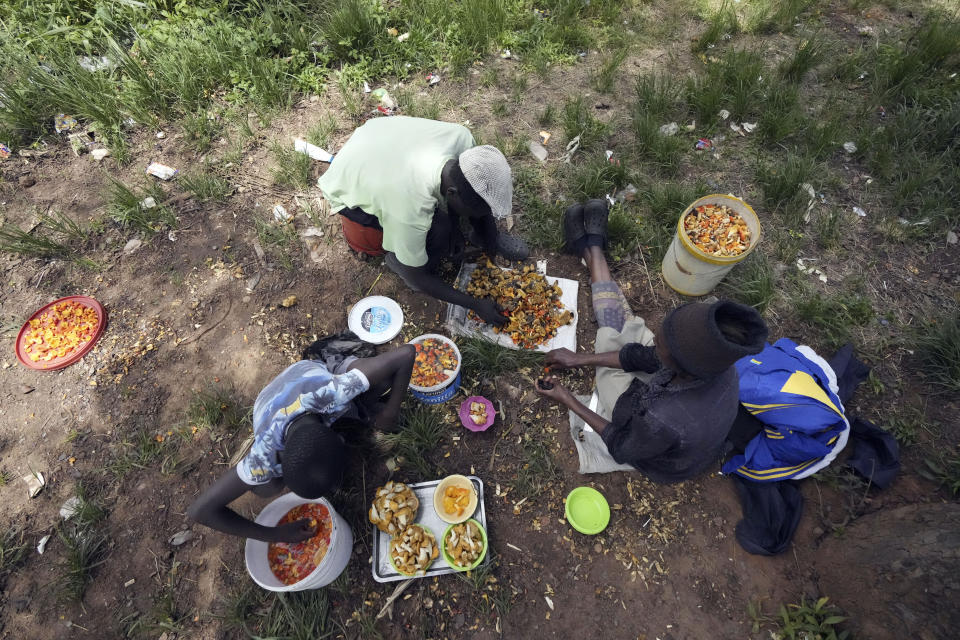 A family use knives and water to clean mushrooms before selling them, on the outskirts of Harare, Tuesday, Feb, 21, 2023. Zimbabwe’s rainy season brings a bonanza of wild mushrooms, which many rural families feast upon and sell to boost their incomes. Rich in protein, antioxidants and fiber, wild mushrooms are a revered delicacy and income earner in Zimbabwe, where food and formal jobs are scarce for many. (AP Photo/Tsvangirayi Mukwazhi)