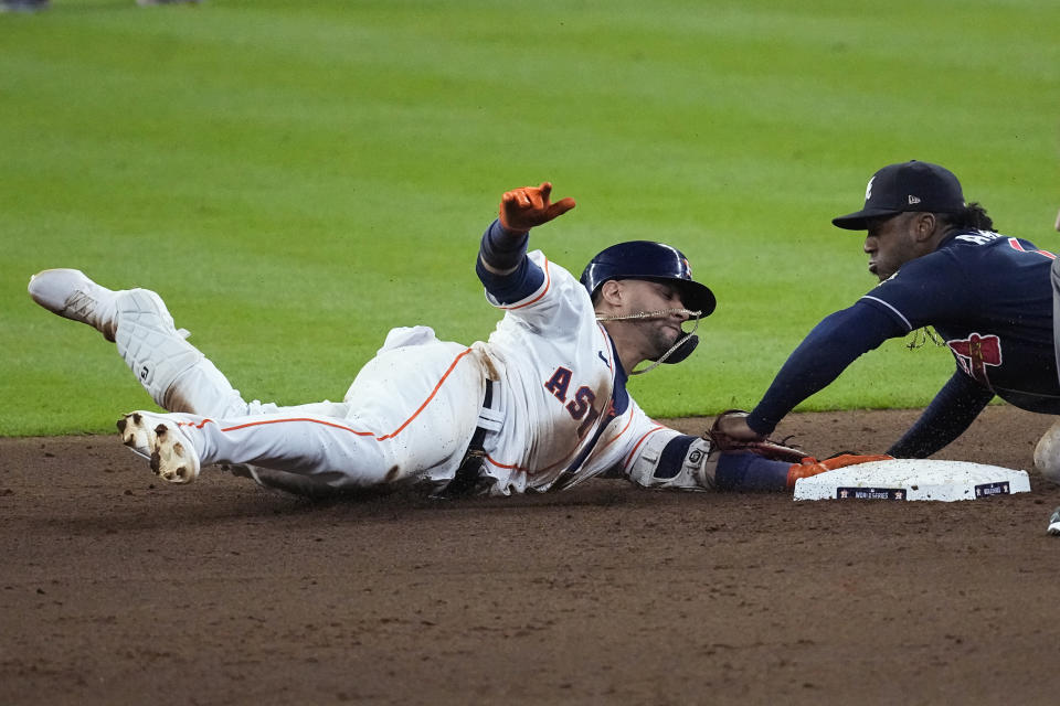 Atlanta Braves second baseman Ozzie Albies tags out Houston Astros' Yuli Gurriel at second during the eighth inning of Game 1 in baseball's World Series between the Houston Astros and the Atlanta Braves Tuesday, Oct. 26, 2021, in Houston.(AP Photo/Sue Ogrocki)