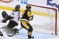 Pittsburgh Penguins' Sidney Crosby (87) skates by Arizona Coyotes goaltender Karel Vejmelka (70) after scoring during the first period of an NHL hockey game Thursday, Oct. 13, 2022, in Pittsburgh. (AP Photo/Keith Srakocic)