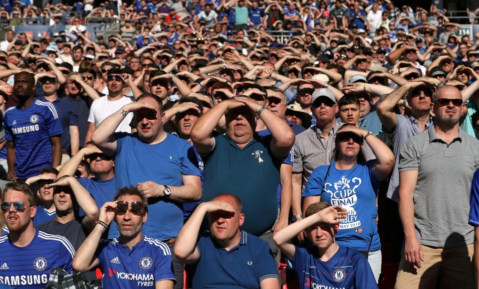 <p>Chelsea supporters shield their faces from the sun during the FA Cup final with Manchester United at Wembley. Chelsea won the game 1-0 to give Antonio Conte a trophy in his final match as Blues head coach, although he was not sacked for another two months (David Davies/PA). </p>