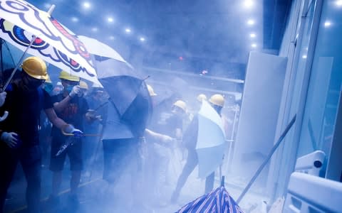 Protesters storm the Legislative Council building on the anniversary of Hong Kong's handover to China in Hong Kong - Credit: Reuters