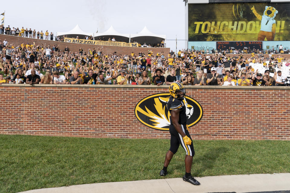 Missouri running back Tyler Badie celebrates his touchdown in front of the end zone crowd during the second quarter of an NCAA college football game against North Texas, Saturday, Oct. 9, 2021, in Columbia, Mo. (AP Photo/L.G. Patterson)