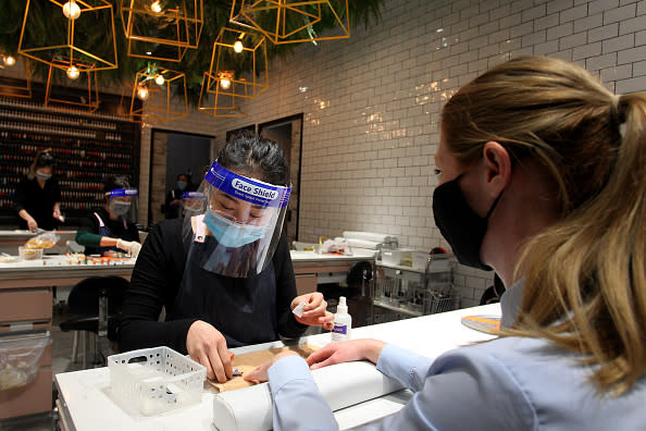 Nail Technician Lily Nguyen is seen wearing a mask and face shield at the Depot Nail Bar in Broadway Shopping Centre, Sydney, Australia. 