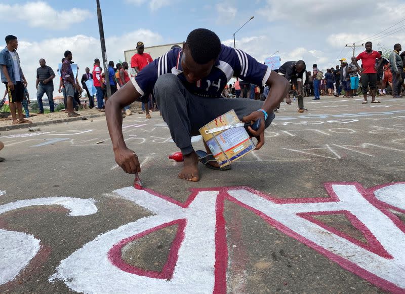 A demonstrator paints 'End Sars' during a protest demanding police reform in Lagos