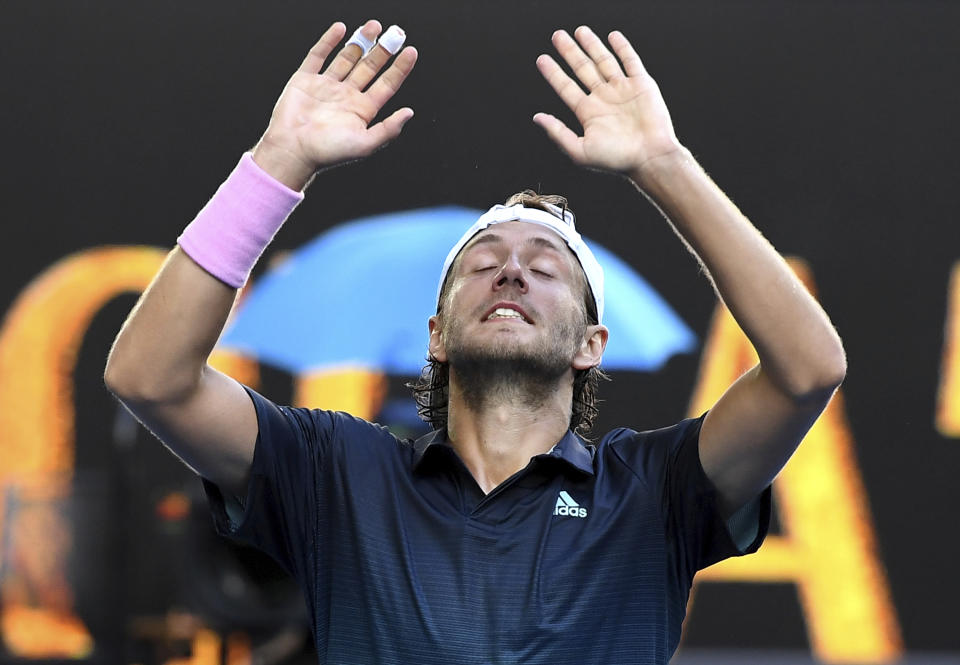 France's Lucas Pouille celebrates after defeating Canada's Milos Raonic in their quarterfinal match at the Australian Open tennis championships in Melbourne, Australia, Wednesday, Jan. 23, 2019.(AP Photo/Andy Brownbill)