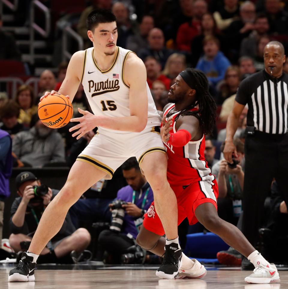 Purdue Boilermakers center Zach Edey (15) is guarded by Ohio State Buckeyes guard Isaac Likekele (13) during the Big Ten Men’s Basketball Tournament semifinal game, Saturday, March 11, 2023, at United Center in Chicago. Purdue won 80-66.