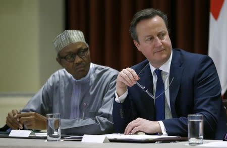 Nigeria's President Muhammadu Buhari (L) and Britain's Prime Minister David Cameron (R) look on during a breakfast dialogue with Youth Leaders at the Commonwealth Heads of Government Meeting (CHOGM) in Valletta, Malta November 28, 2015. REUTERS/Andrew Winning
