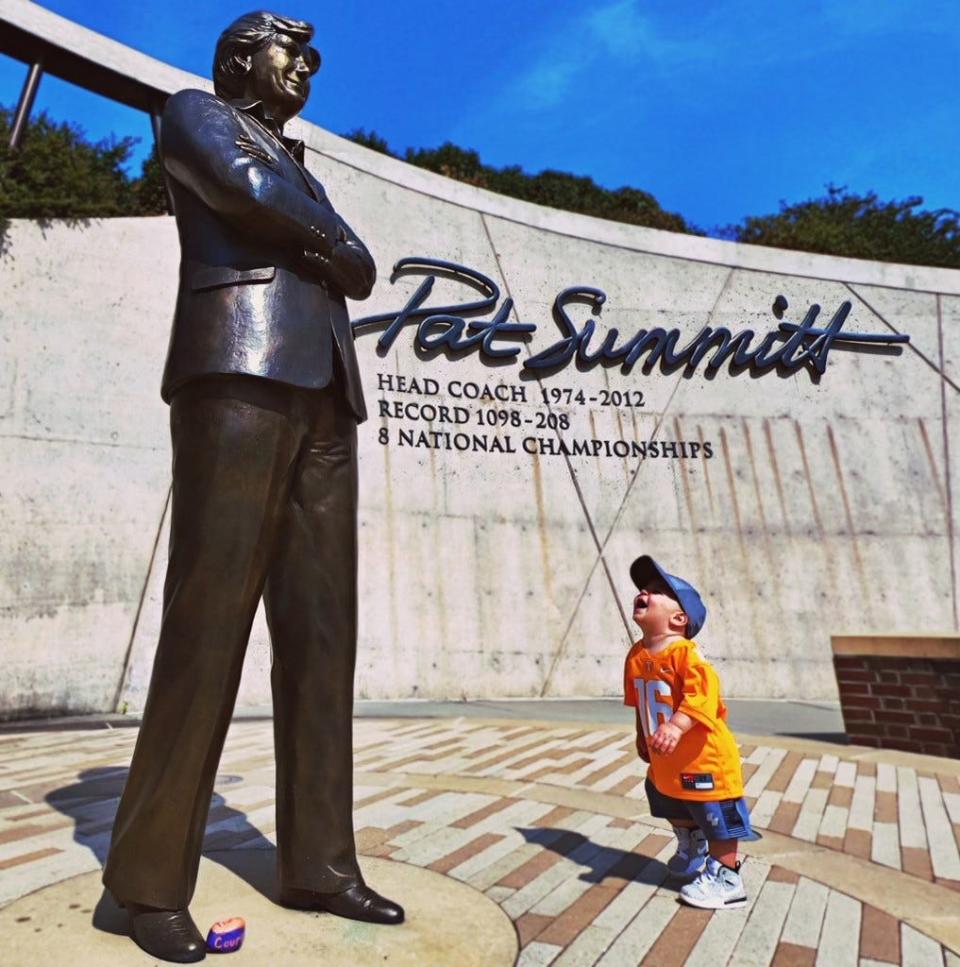 Breck Summitt stands at the base of a statue of his grandmother, legendary coach Pat Summitt.