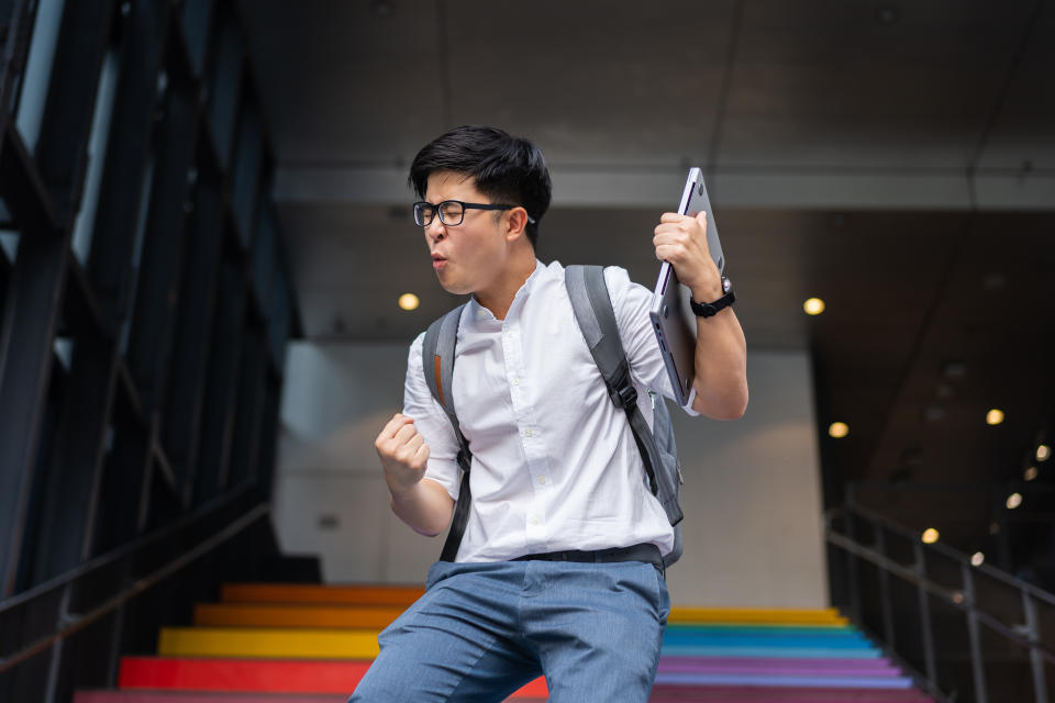 self-worth Portrait of success Asian young businessman arm raised