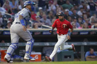 Minnesota Twins' Luis Arraez scores past Kansas City Royals catcher Salvador Perez during the fifth inning of a baseball game Monday, Aug. 15, 2022, in Minneapolis. (AP Photo/Abbie Parr)