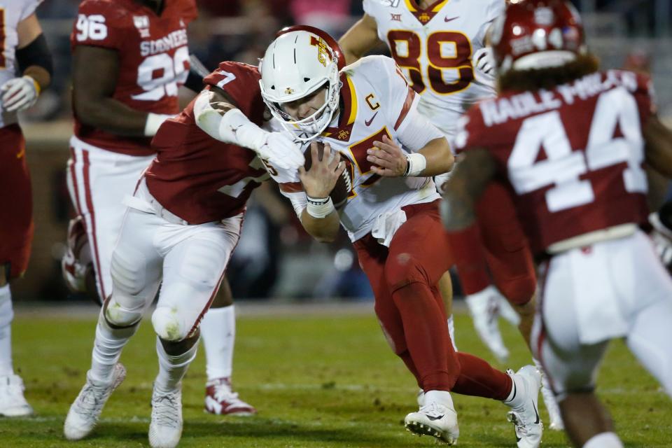 Iowa State quarterback Brock Purdy (15) is tackled by Oklahoma defensive lineman Ronnie Perkins (7) during the second quarter of an NCAA college football game in Norman, Okla., Saturday, Nov. 9, 2019.