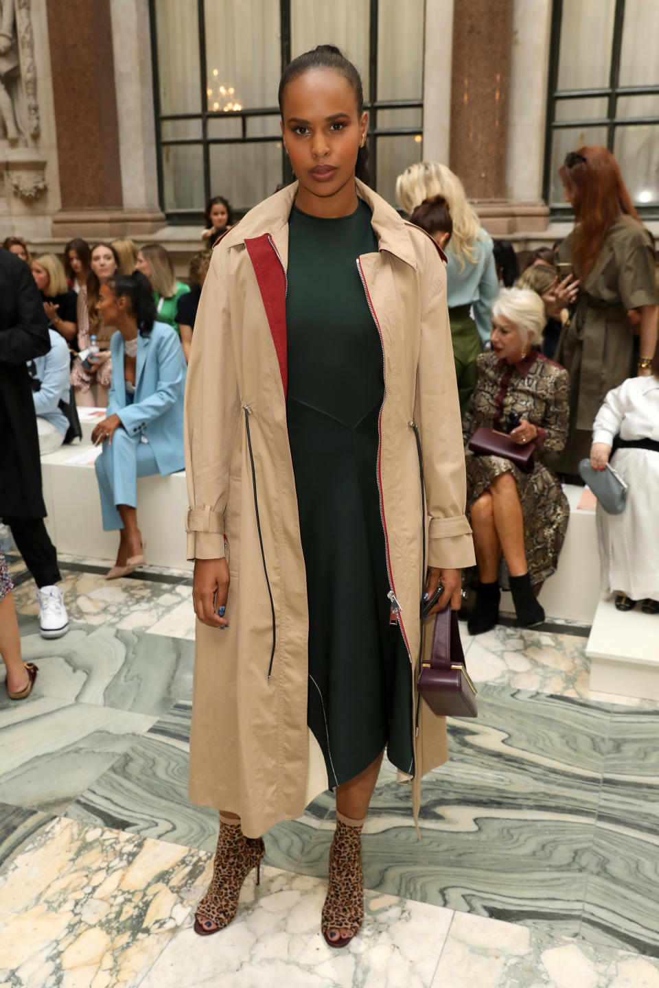 Sabrina Elba wore a trench coat and leopard print boots to the show [Photo: Getty]