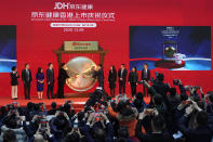 JD Health executives sound the gong during a ceremony to mark the listing of the company stock on the Hong Kong Stock Exchange at the JD Headquarters in Beijing Tuesday, Dec. 8, 2020. Shares in China's biggest online health care platform rose 40% in their Hong Kong stock market debut Tuesday, reflecting investor enthusiasm for the fledgling industry as the country emerges from the coronavirus pandemic. AP Photo/Ng Han Guan)