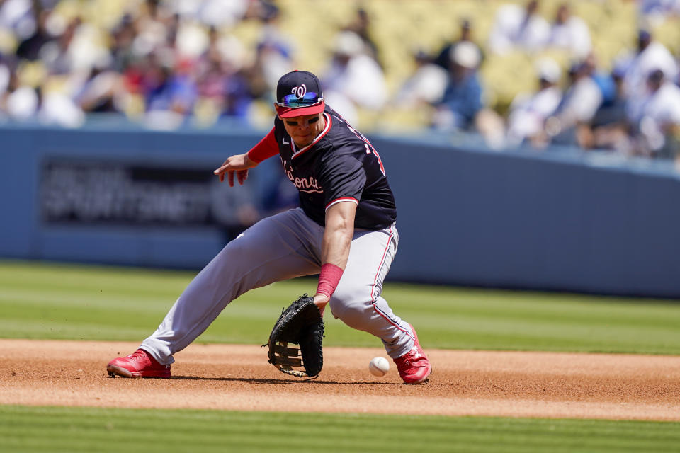 Washington Nationals first baseman Joey Meneses fields a ground hit by Los Angeles Dodgers' Teoscar Hernandez during the fourth inning of a baseball game, Wednesday, April 17, 2024, in Los Angeles. (AP Photo/Ryan Sun)