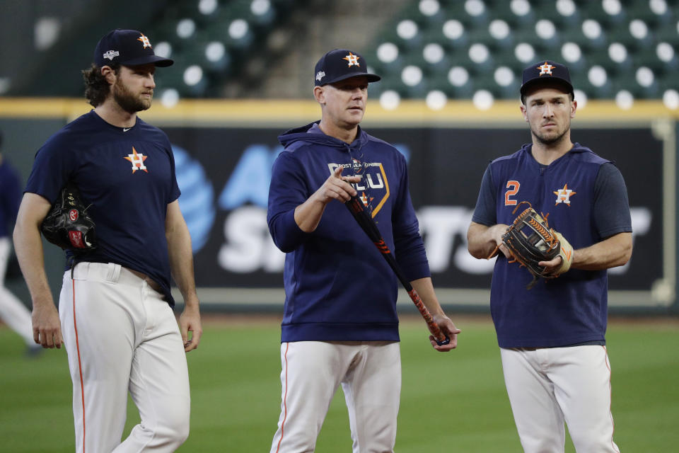 Houston Astros starting pitcher Gerrit Cole, left, manager AJ Hinch, center, and third baseman Alex Bregman, right, talk during a practice for a baseball American League Championship Series in Houston, Friday, Oct. 11, 2019. Houston will face the New York Yankees, Saturday. (AP Photo/Eric Gay)